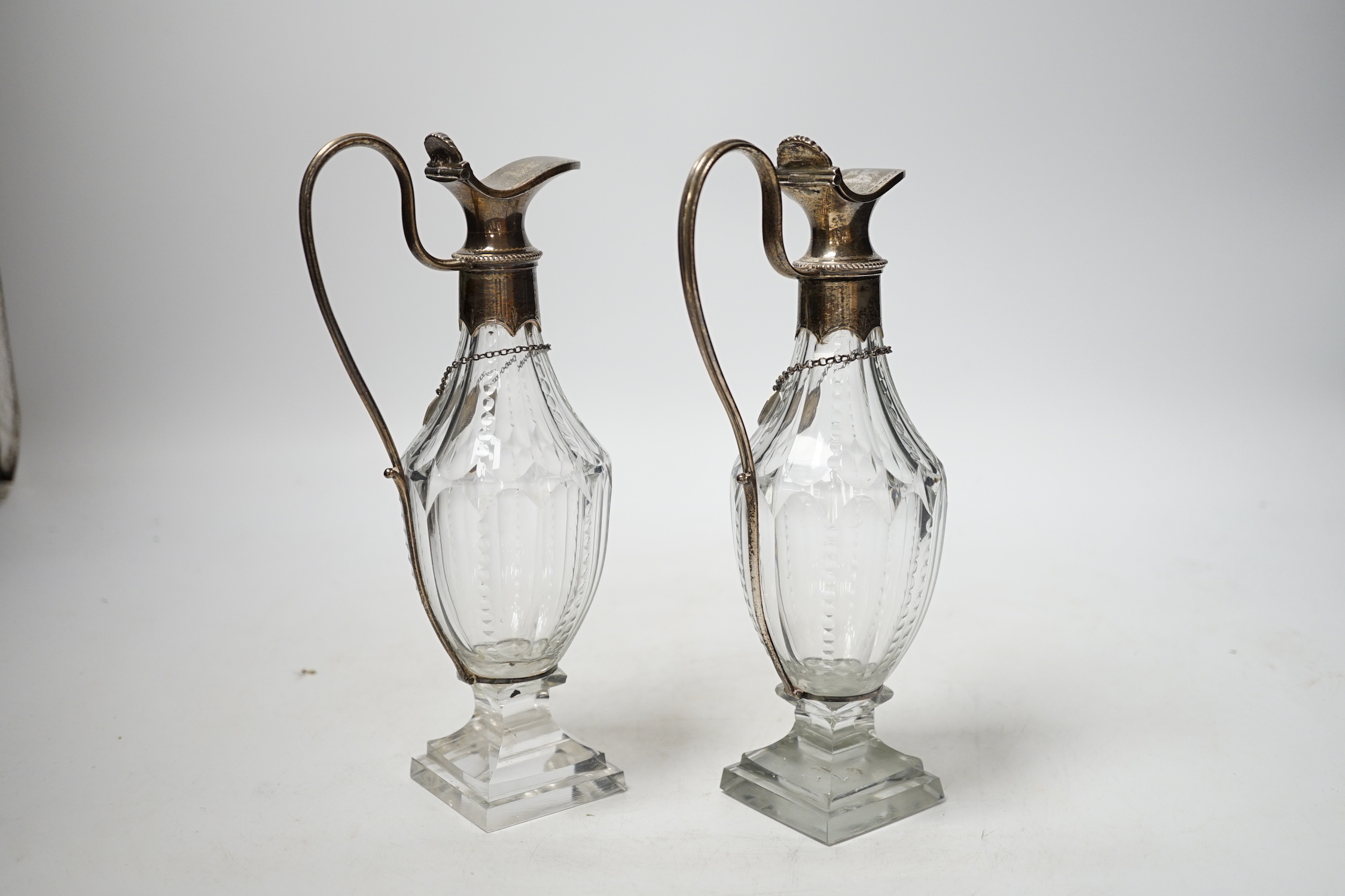 A pair of late 18th/early 19th century silver mounted cut glass cut glass cruet bottles with labels for Cayenne and Soy, makers mark only on mounts and labels for Phipps & Robinson, circa, 1800, height 20.5cm.